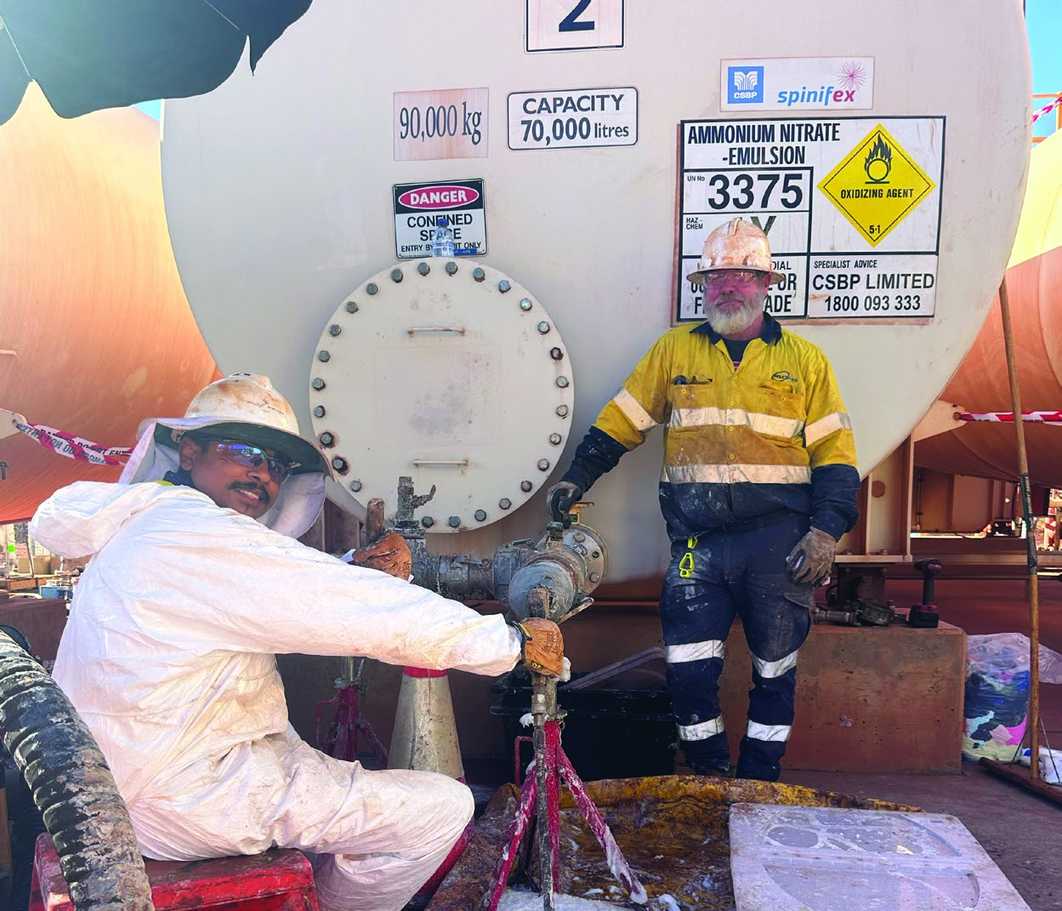 GSD WA workers cleaning an industrial tank through an access hatch